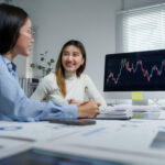 businesswomen discussing stock market data in offi 2025 09 14 06 29 01 utc Why Serious Traders Rely on a Forex VPS for Uninterrupted Automation