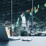 Creative workplace with laptop, coffee cup, supplies and forex chart on window with night city view. Trade and finance concept. Multiexposure