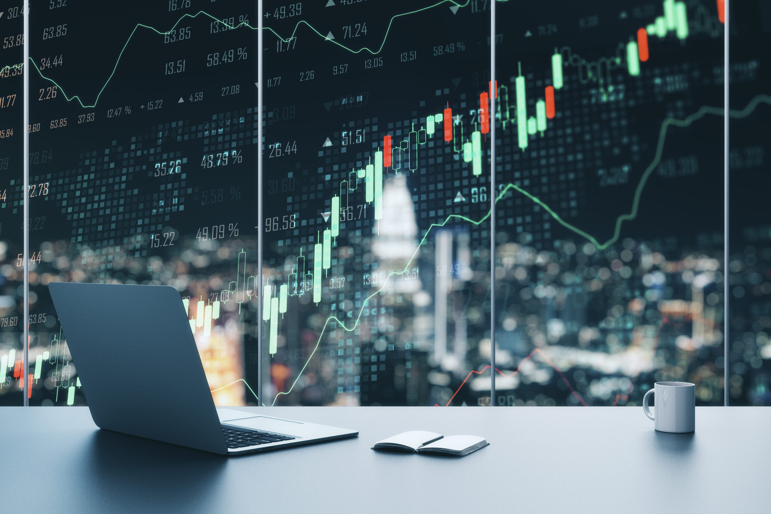 Creative workplace with laptop, coffee cup, supplies and forex chart on window with night city view. Trade and finance concept. Multiexposure