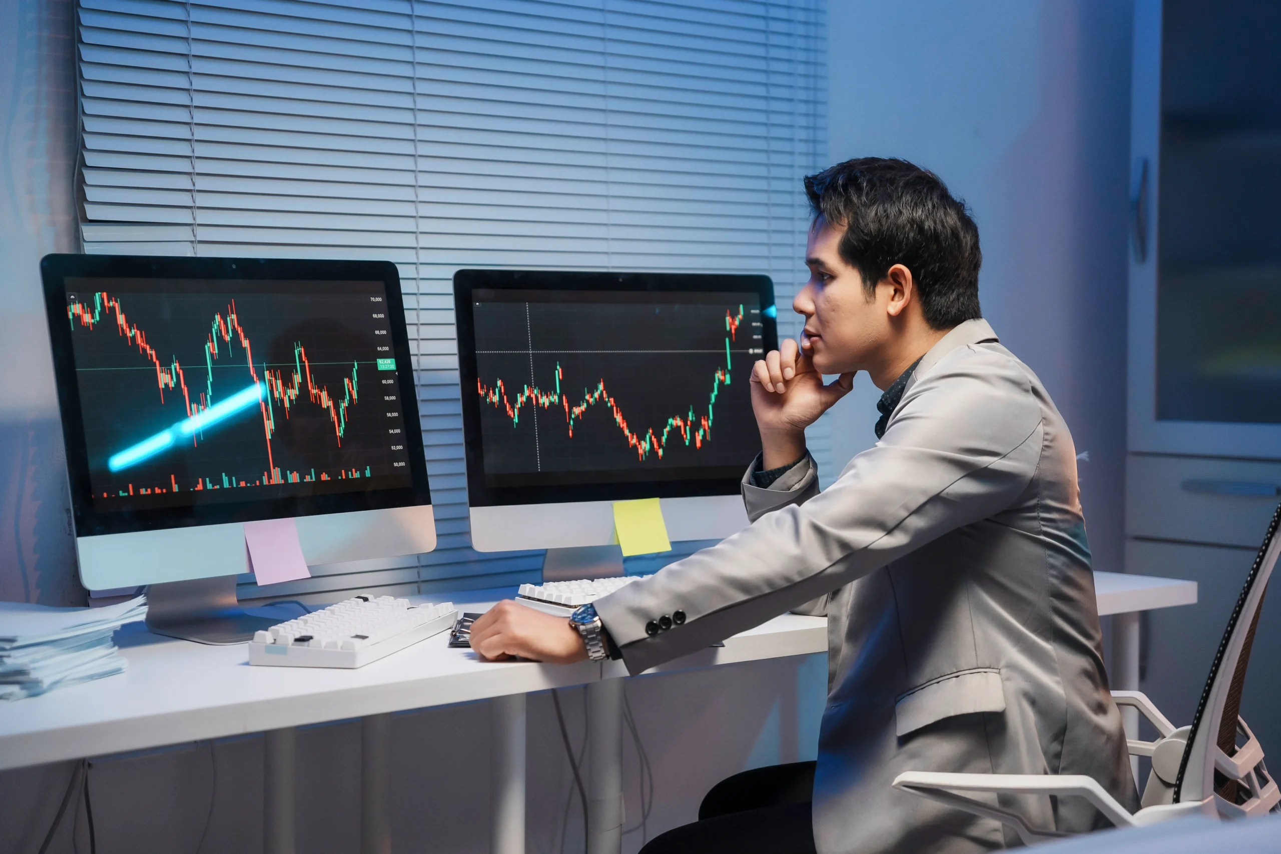 stock-trader-analyzing-charts-on-computer-screens