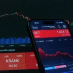 Mobile app showing stock market data with charts on screen