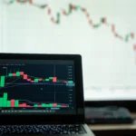 Close-up-of-a-laptop-showing-cryptocurrency-market-charts-in-a-trading-environmen